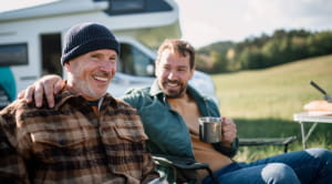 Two men on deckchairs outside motorhome - credit Getty Images